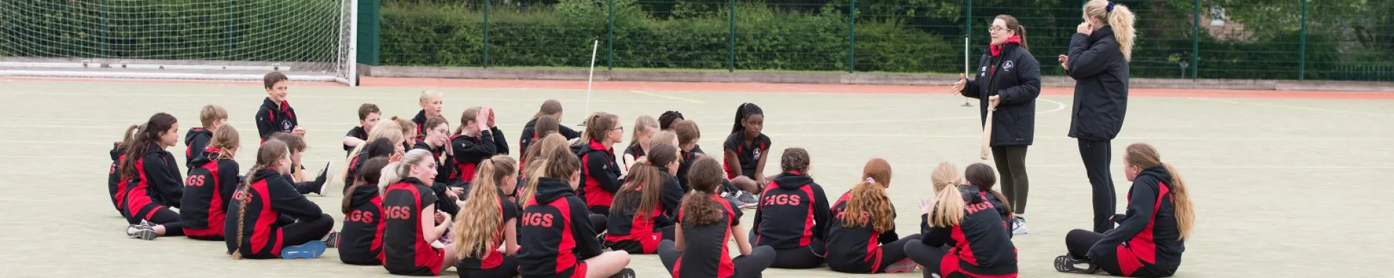 Row of students listening to sports leaders